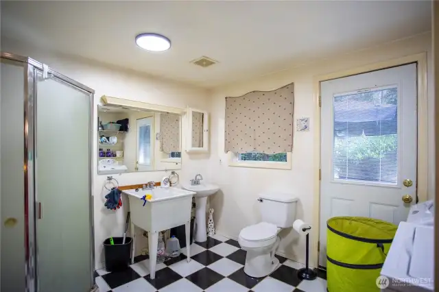 Huge utility 3/4 bathroom with exit door to the back deck. Washer and dryer stays