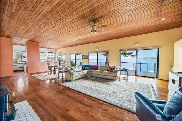 The open floor plan seamlessly connects the living room, dining area, and kitchen—all designed to take full advantage of the sweeping southerly views over Padilla Bay. A perfect blend of space, light, and waterfront beauty.