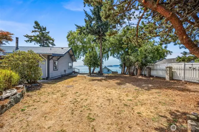 West side entry welcomes you through the gated drive, where two full RV hookups await complete with power, water, and septic. Perfect for guests or extended stays, this unique setup blends comfort and convenience in a truly one-of-a-kind waterfront setting.