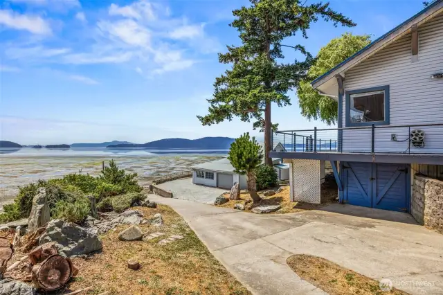 Looking down the driveway and boat ramp beneath the home, you'll find a convenient work area complete with a bench and additional storage—ideal for marine gear, tools, or projects.