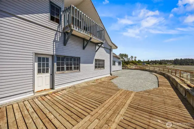 Front exterior of the cannery featuring a charming upstairs balcony - an ideal spot to enjoy fresh air and scenic views overlooking the property and waterfront.