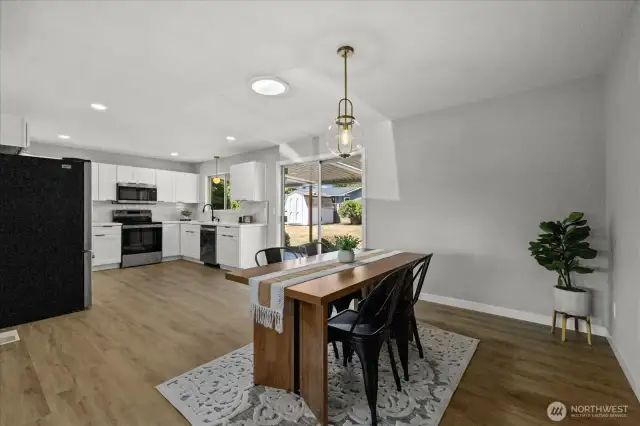 Bright dining area flows seamlessly from the kitchen with direct backyard access