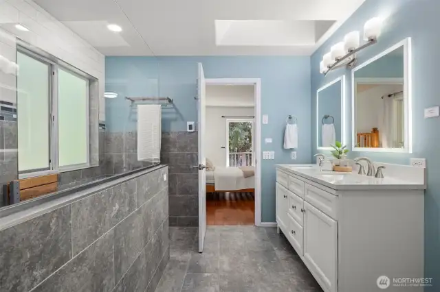 Your going to love this shower! Recently updated primary bathroom with LED back lit mirrors a resting bench and plenty of room.