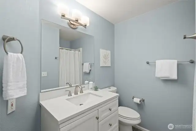 Guest bathroom on the main floor with walk in shower, tile floors and updated fixtures.