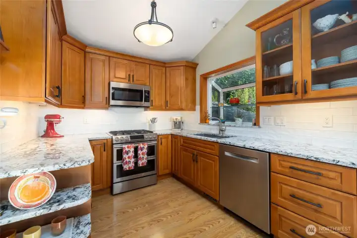 Fully refreshed kitchen with beautiful wood cabinetry, granite counters, stainless appliances and so much storage.