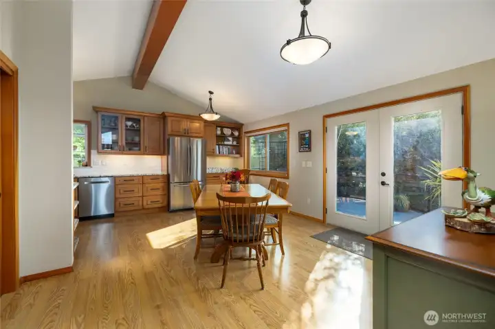 Open concept dining room and kitchen with vaulted ceilings and french doors that open to a wonderful deck.