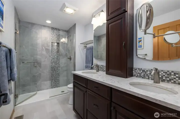 Beautifully updated primary bathroom with double sink vanity and walk-in shower.
