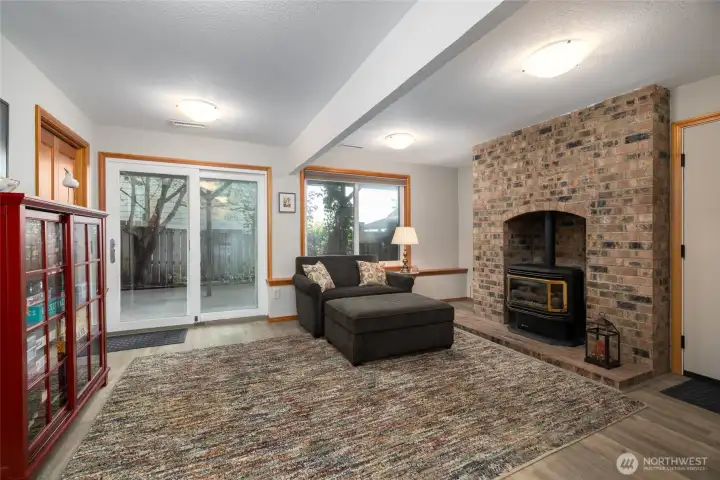 Downstairs family room with gas fireplace, so much storage, access to garage and sliding door leading to the beautiful outdoor spaces.