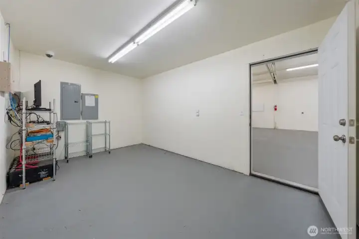Office inside shop featuring monitored security system and generator panel.