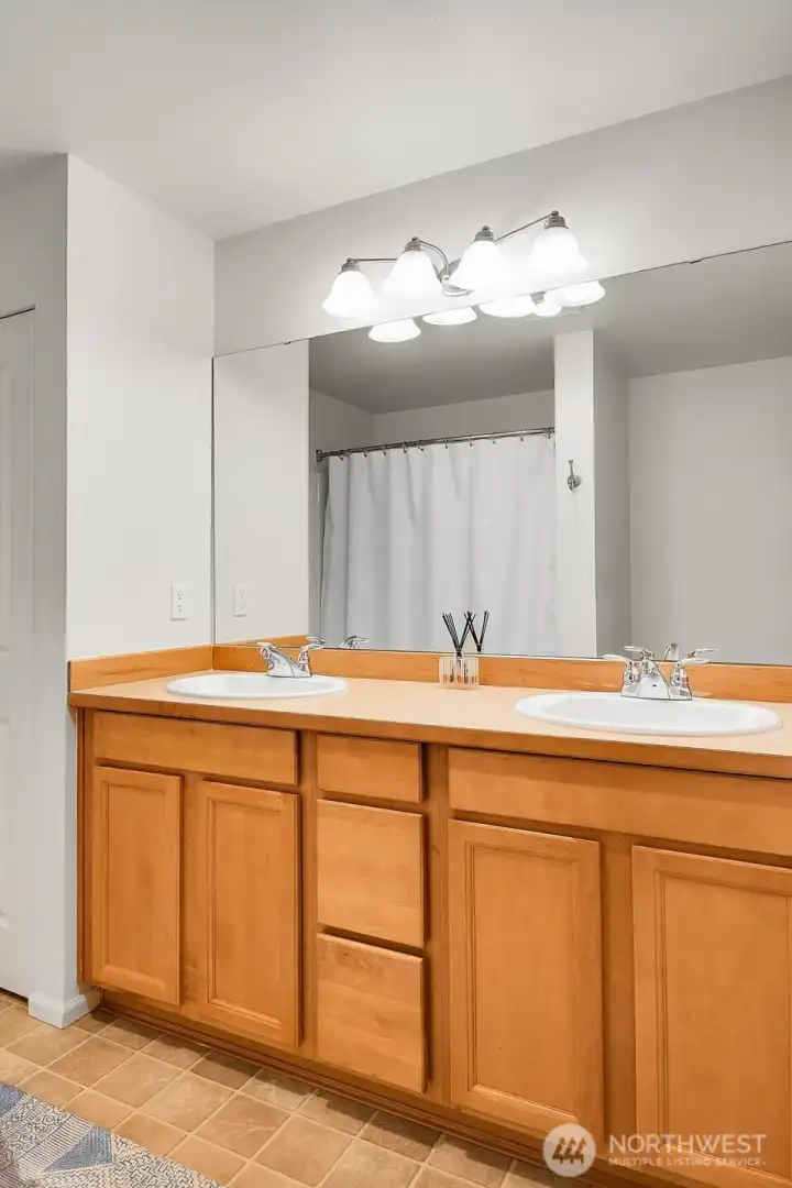 Primary en-suite bathroom. Full-sized W/D located across from bathroom in hall closet.