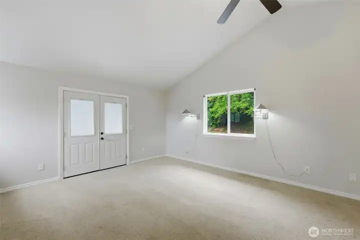 Main house primary bedroom with french doors to private lanai