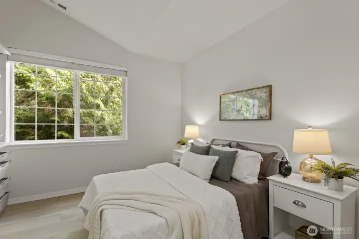 The second bedroom is nice and spacious as well, with a serene treed view right outside.