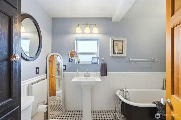 Main floor spa inspired bath with pedestal sink, tub & shower.