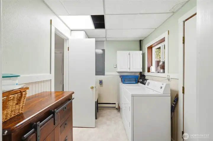 Wainscot, plenety of elbow room and new vinyl tile floor make laundry day bearable.
