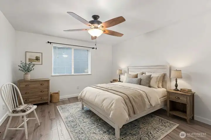 Primary suite with ceiling fan, walk in closet and remodeled full bathroom ensuite. (decor digitally staged)