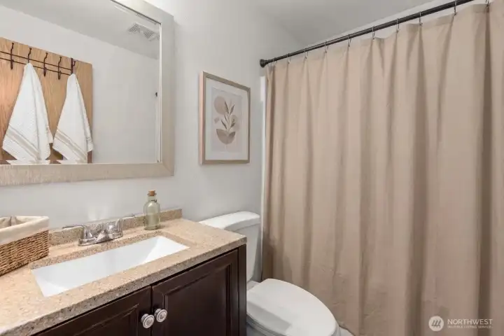 Full bath upstairs. (some decor digitally staged)