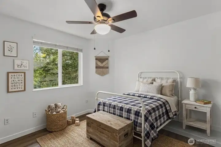 Bedroom 2 of 3 upstairs. (decor digitally staged)