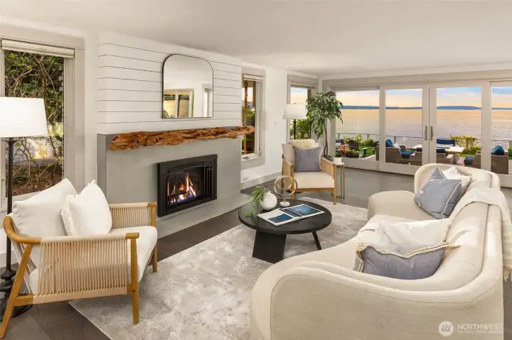 Living area surrounded by windows and breathtaking views! Gas fireplace with custom driftwood mantel.