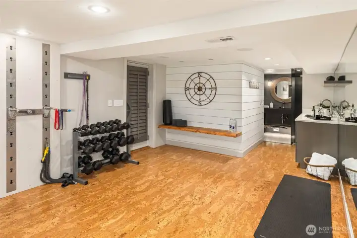 Lower level expands your options with a versatile space featuring a workout area, Murphy bed, media setup, and a spa-like steam shower bath—perfect for guests or downtime.