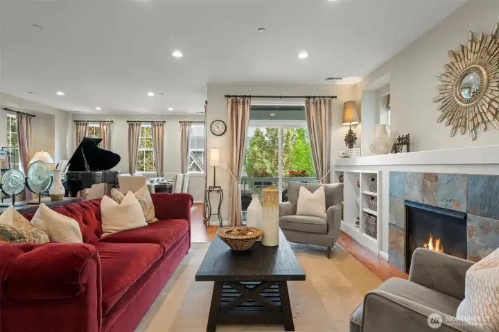Light filled living room with gas fireplace.