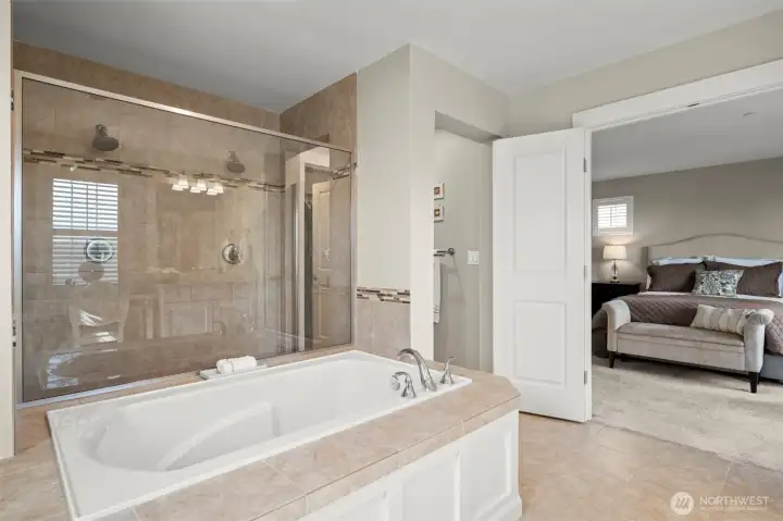 Deep soaking tub with separate walk-in shower.