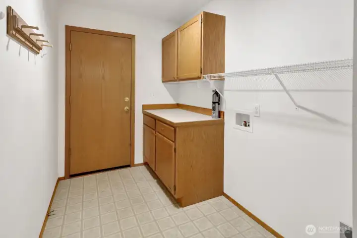 Laundry room is located just off the garage.