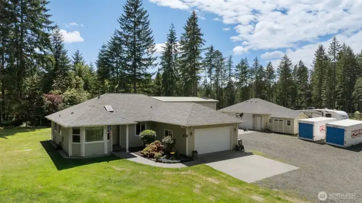 From above, the property’s scale comes into focus, offering a rare blend of home, workspace, open lawn, and natural Northwest beauty.