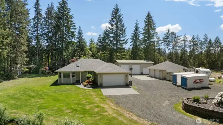 This elevated angle brings the full layout together, showing how the home, shops, outbuildings, drive, and grounds are thoughtfully arranged for both everyday living and serious utility.