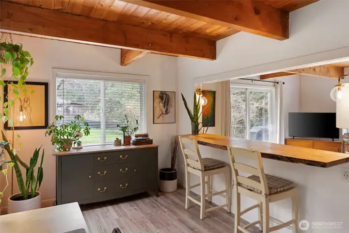 The live-edge bar is open to the living room and is great for those informal meals when the game is on and you just can't miss it. The live-edge bar is open to the living room and is great for those informal meals when the game is on and you just can't miss it.