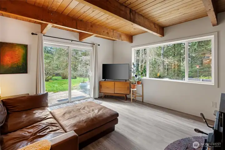 The living room area offers a sliding door to the side deck and yard beyond and the large window lets you enjoy all that nature has to offer outside. A woodburning stove for those cold nights is such a bonus to keep down your electric bill. The living room area offers a sliding door to the side deck and yard beyond and the large window lets you enjoy all that nature has to offer outside. A woodburning stove for those cold nights is such a bonus to keep down your electric bill.