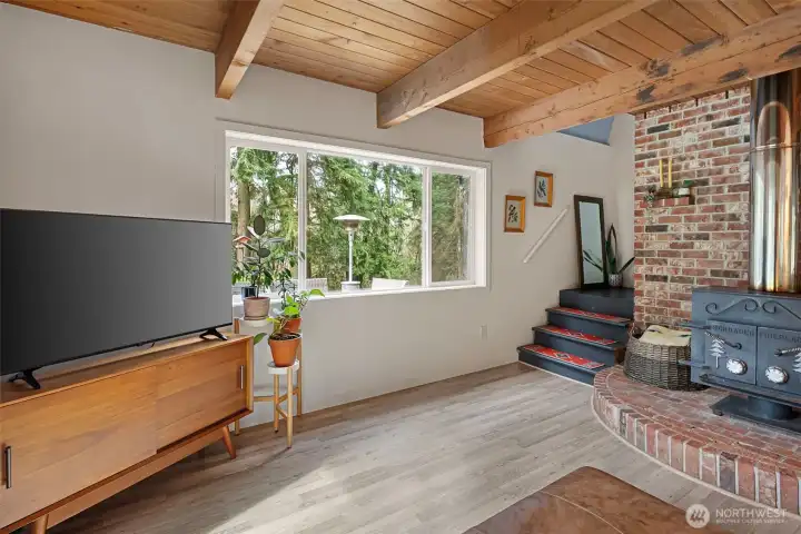 Now that is a hearth! The cast iron wood stove is solid and top of the line. Stairs lead to the upper floor where you'll find the bedrooms and full bath. Now that is a hearth! The cast iron wood stove is solid and top of the line. Stairs lead to the upper floor where you'll find the bedrooms and full bath.