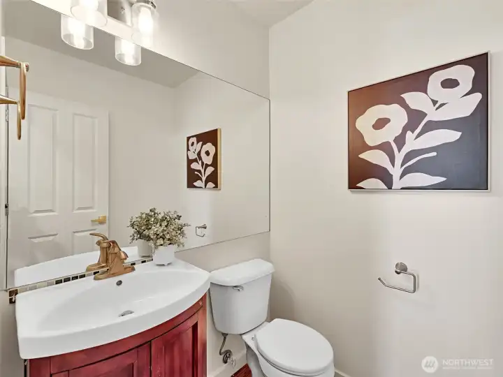 The main floor half-bath is tucked away from the living and dining spaces The main floor half-bath is tucked away from the living and dining spaces