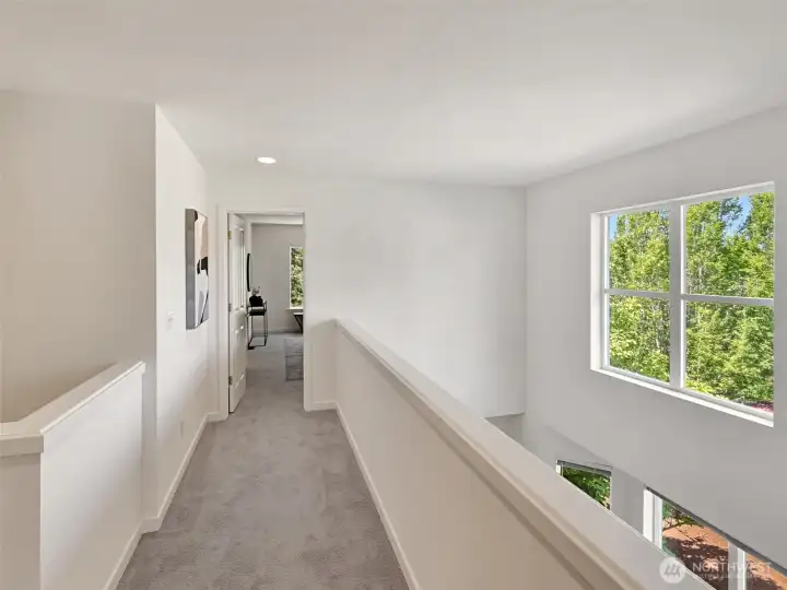 Upstairs, the primary suite is thoughtfully separated from the guest rooms, offering privacy Upstairs, the primary suite is thoughtfully separated from the guest rooms, offering privacy