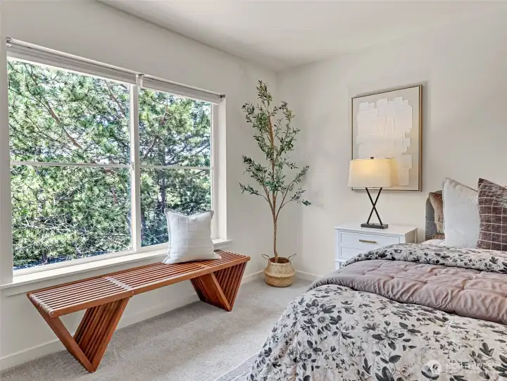 The tree-lined views toward the back yard offers the primary bedroom privacy and quiet The tree-lined views toward the back yard offers the primary bedroom privacy and quiet