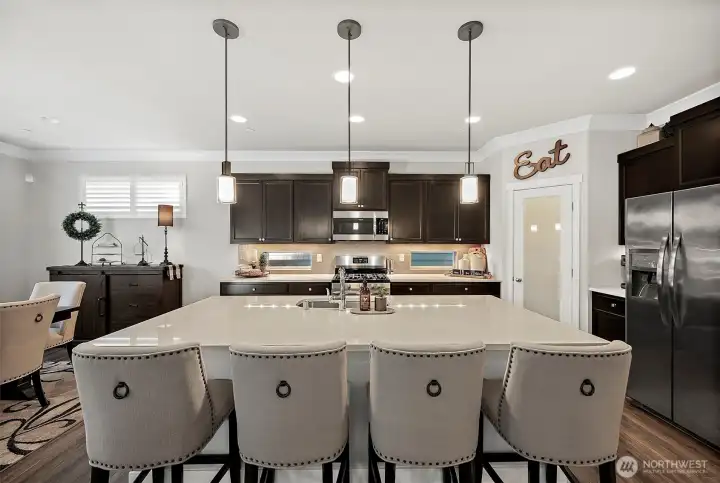 Warm cabinetry, quartz countertops and subway tile backsplash creates a gorgeous space for crafting your meals Warm cabinetry, quartz countertops and subway tile backsplash creates a gorgeous space for crafting your meals