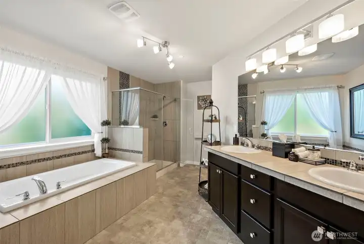 The ensuite bath features a large shower and soaker tub with tile surround where you relax with a bubble bath and soak away the cares of the day The ensuite bath features a large shower and soaker tub with tile surround where you relax with a bubble bath and soak away the cares of the day