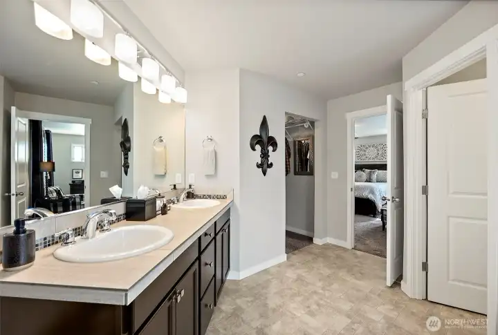 The vanity features double sinks, tile countertop & backsplash and the toilet closet is nicely private The vanity features double sinks, tile countertop & backsplash and the toilet closet is nicely private