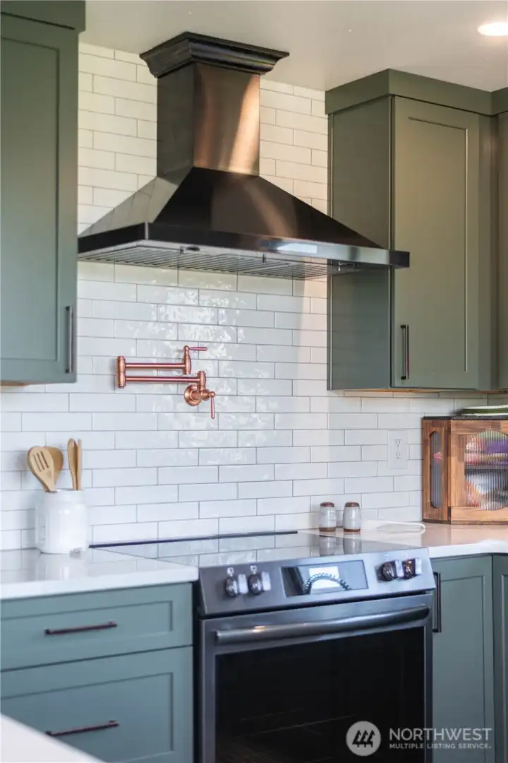 Hot water tap for your cooking convenience! Copper finishes make this kitchen pop!