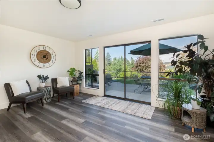 Larger slider lead onto a large patio with fish pond, opening into gardens and fully fenced yard