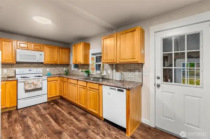Large kitchen w/ loads of prep/storage space & an additional enclosed storage area w/ basement access