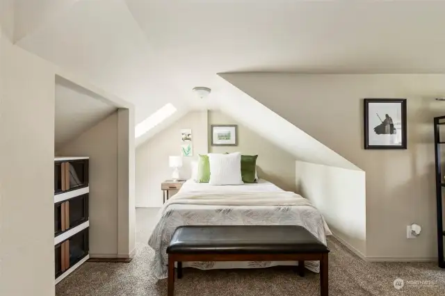 Head upstairs to the second bedroom.  Notice the natural light showering down from the skylight!