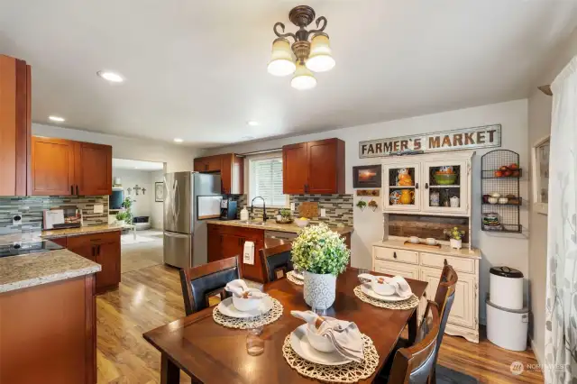 Around the corner, you'll find a nicely-sized dining area with large kitchen.