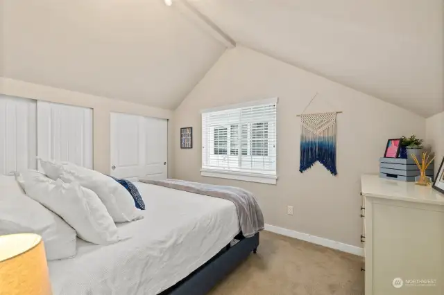 One of two upper level bedrooms with vaulted ceilings and ample space for a king size bed and dresser.