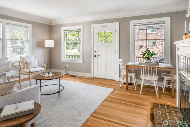 The charming Living Room with refinished oak floors includes a sweet dining area.