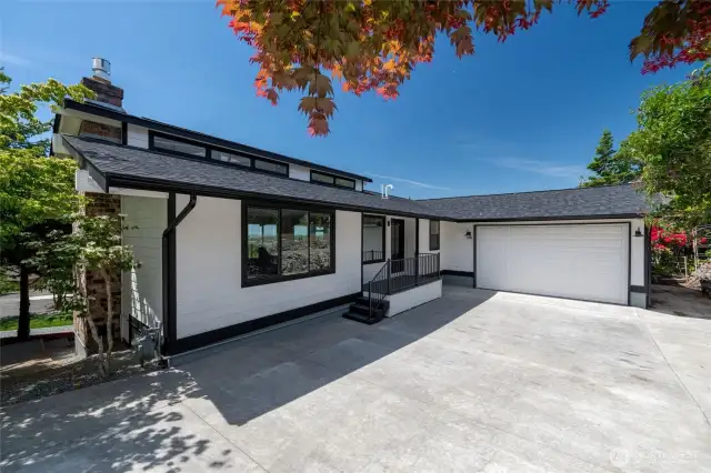 Show-stopping modern exterior with newly poured driveway and attached 2-car garage.