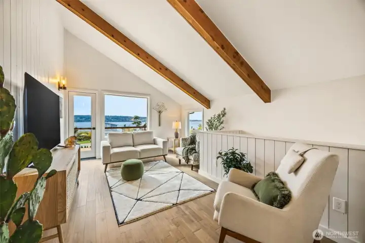 Heading upstairs there is a living area with french door to the upstairs deck and beautiful views!