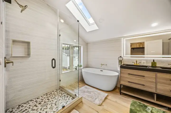Bathroom floors are tiled with a wood look...walls are tiled, double vanity here and second laundry in the bi-fold door closet/linen space.