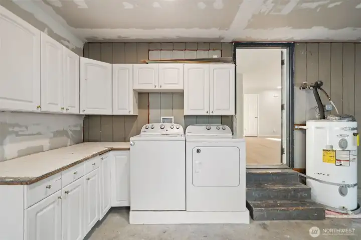 The laundry area is in the garage. TONS of storage here too.