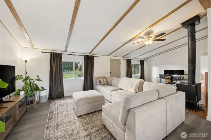 Living/Great room.  New paint, trim, doors, LVP flooring in main areas; carpet in the bedroom.  Functioning wood stove as secondary heat source.