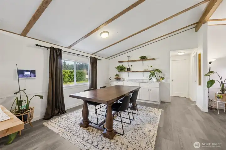 Dining room area with new built in storage and hallway to bedrooms 2 and 3.  Full bath redone in 2024.